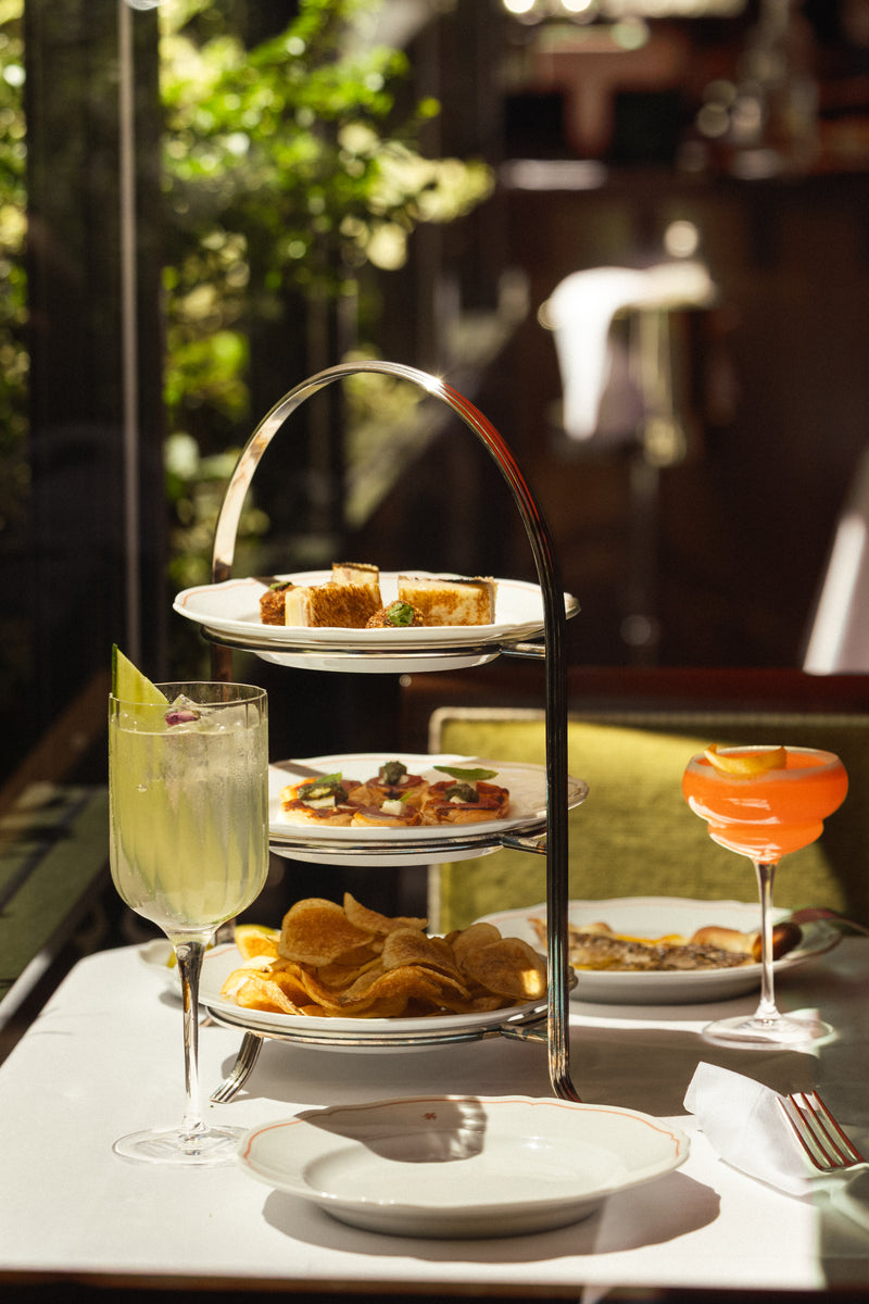 a three tiered tray with food on it