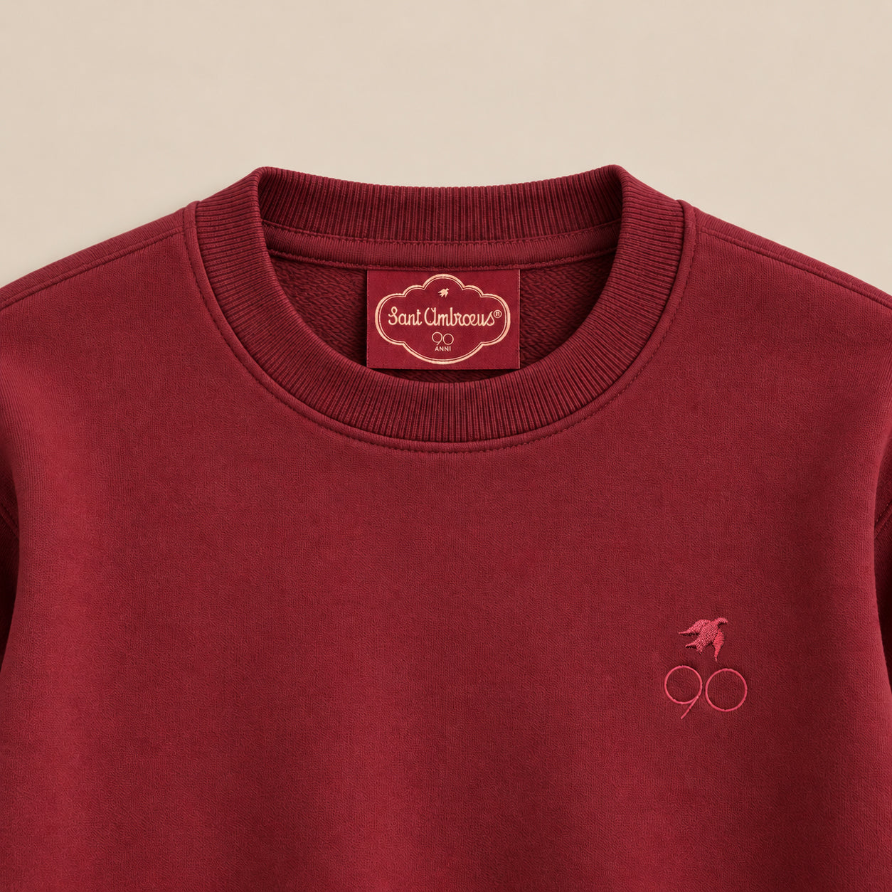 a red sweater with a logo on it