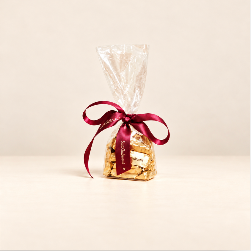 a bag of chocolates with a red ribbon