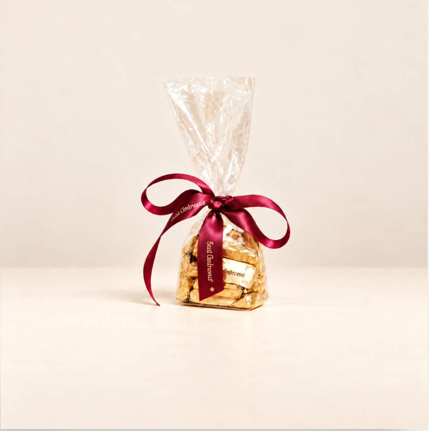 a bag of chocolates with a red ribbon